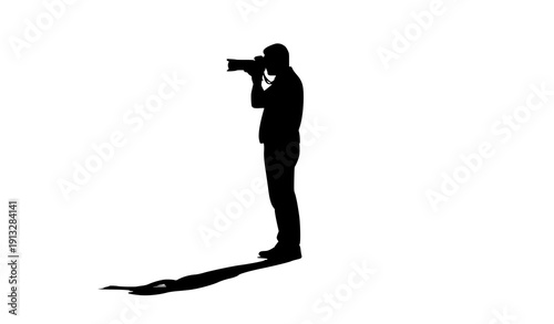 The Photographer's Gaze: A silhouette of a dedicated photographer capturing a moment with a long camera lens.
