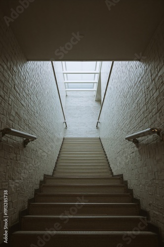 Stairs Leading to an Upper Level With Light Coming Through the Skylight