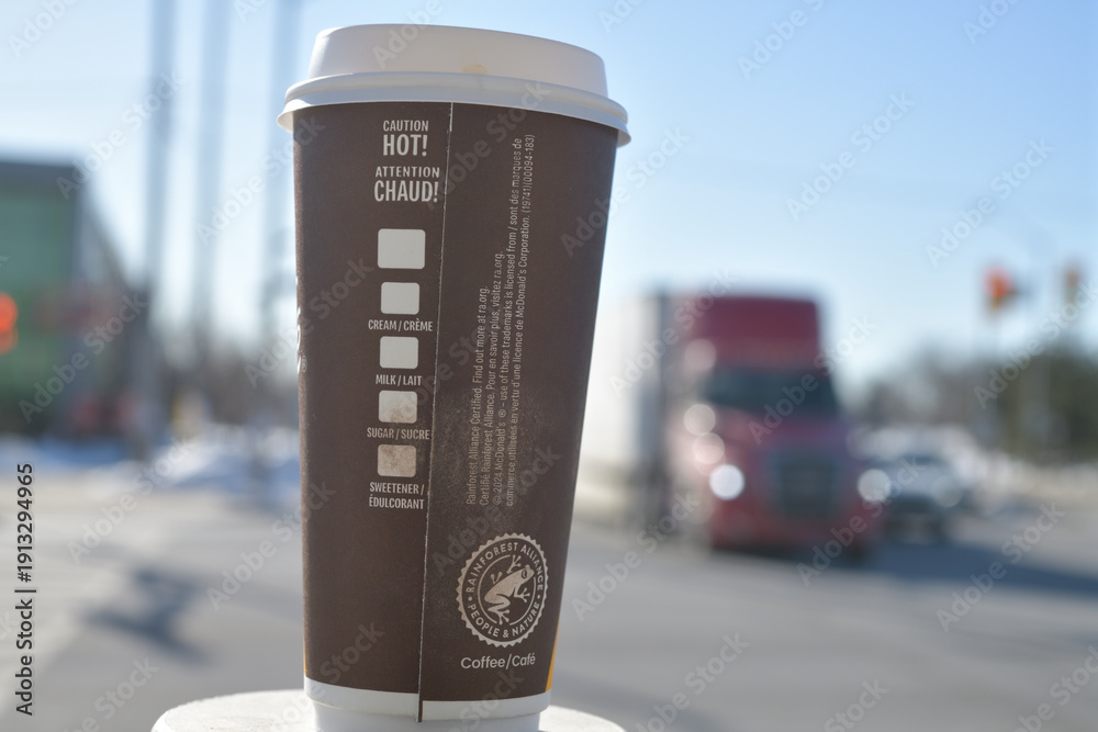 Fototapeta premium McDonald's Canada McCafé large beverage cup (back side) outdoors in Toronto