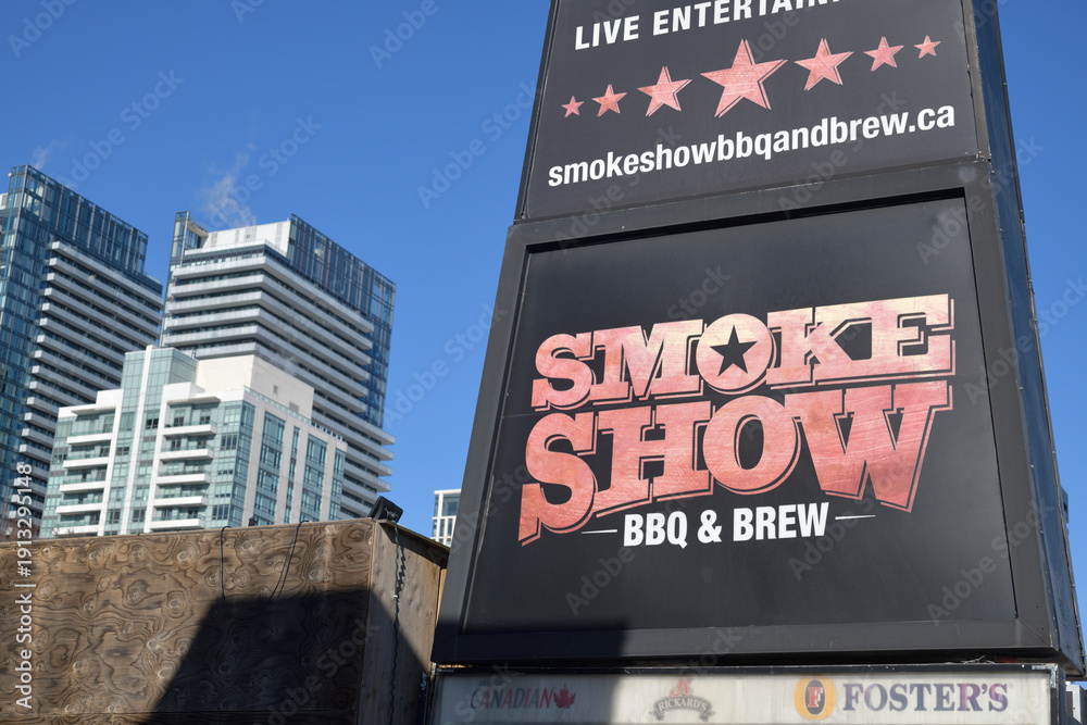 Fototapeta premium close-up of road side billboard for Smokeshow Bbq and Brew located at 744 Mt Pleasant Rd, Toronto