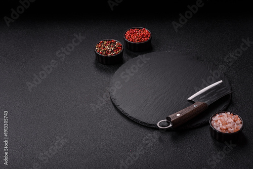 An empty slate cutting board with cutlery on a kitchen counter. Slate cutting board