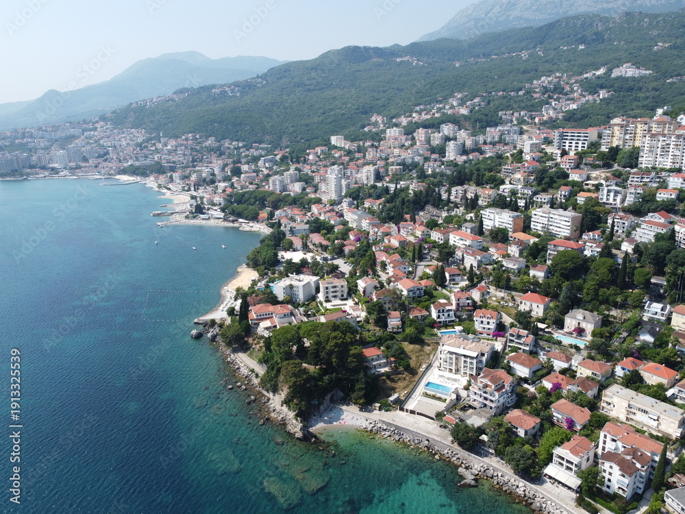 Fototapeta premium Picturesque Coastal Cityscape With Turquoise Water and Mountain Backdrop