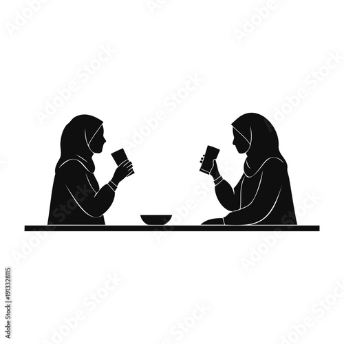 Silhouette of Two Muslim Women Drinking and Socializing