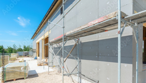 Building exterior wall with insulation and scaffolding