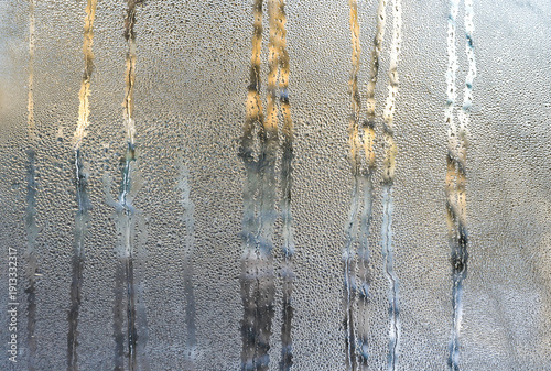 Canvas Print Condensation covering wet glass surface with flowing water streaks