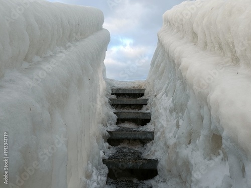 Photography frozen staircase  on a bridge on the beach in copenhagen in winter