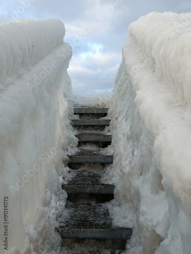Photography frozen staircase  on a bridge on the beach in copenhagen in winter