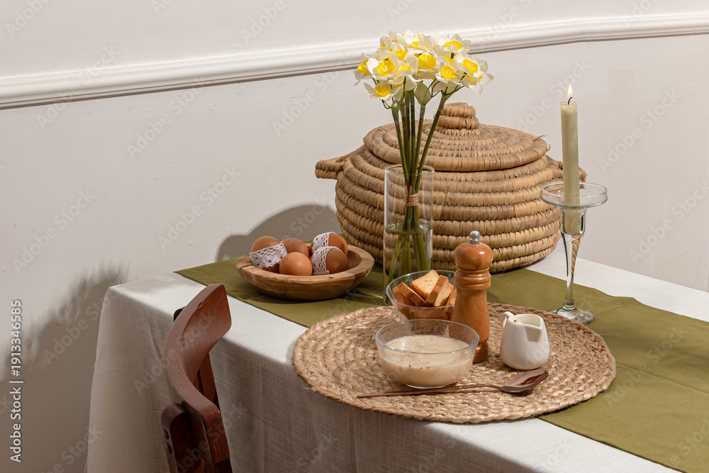Fototapeta premium Cozy Rustic Breakfast Table with Soup, Bread and Spring Flowers