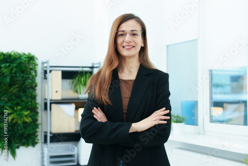 Free Download Portrait of smiling recruiter in suit and glasses with crossed arms in office - GFXLoad