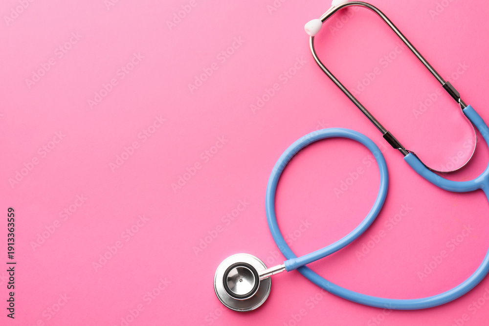 Fototapeta premium One stethoscope on pink background, top view. Space for text