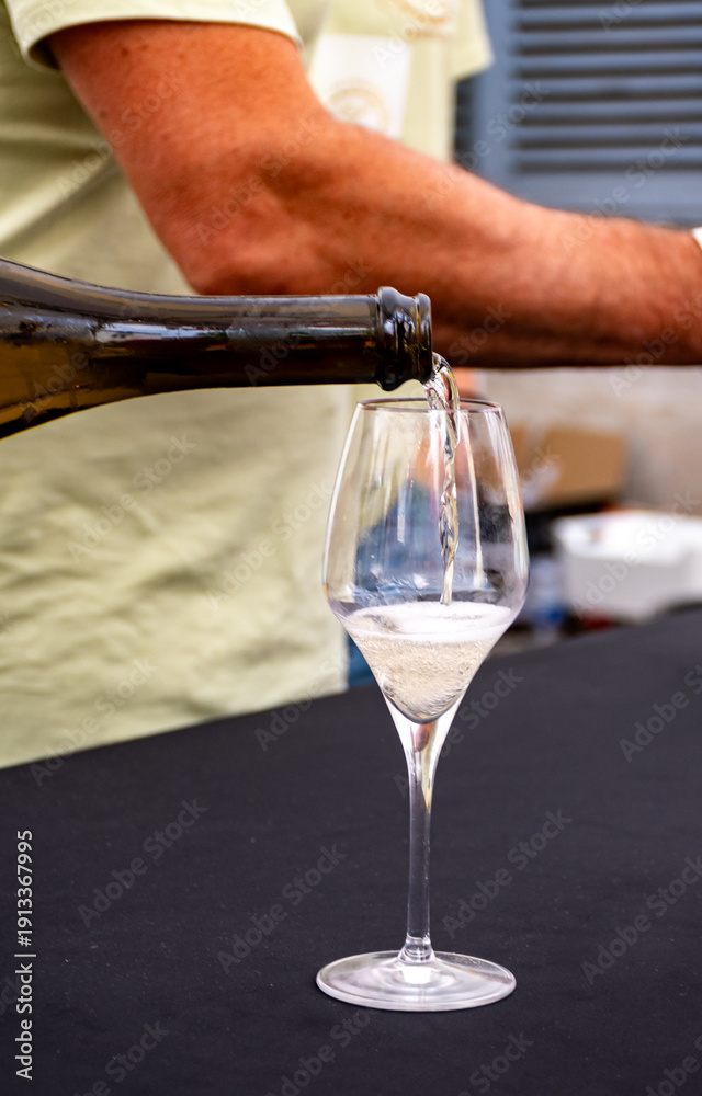 Fototapeta premium Tasting of vintage champagne sparkling wine on yearly Champagne festival in Cote des Bar, France, summer travel destination
