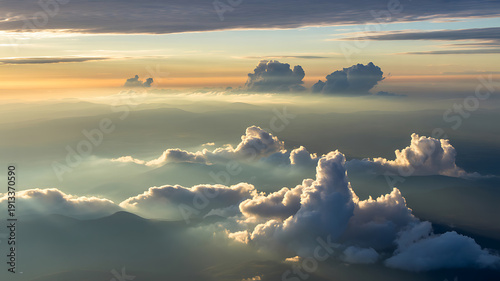Dreamlike aerial cloudscape with sun rays and mountain peaks aerial view mountains