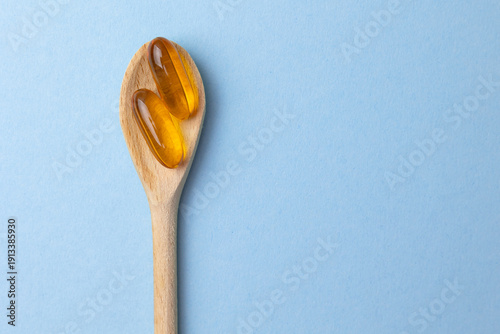 Fényképezés Studio Shot Of Golden Omega Three Softgels Emphasizing Reflectivity And Purity I