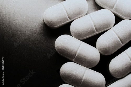 Pharmaceutical Industry: White Pills Arranged Neatly on Dark Background in Close-Up Conceptual Shot Copy-space