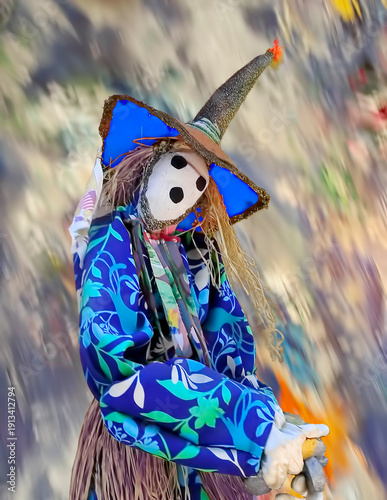 A mask costume doll sits lonely, watching pedestrians walking by