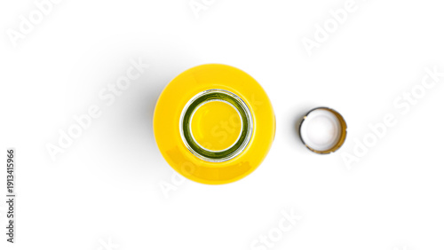 Obraz na płótnie Opened bottle of yellow drink on a white background