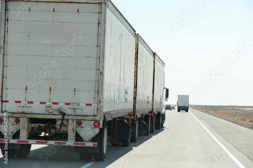 USA, Idaho, Boise.  Truck with three trailers on interstate 84.