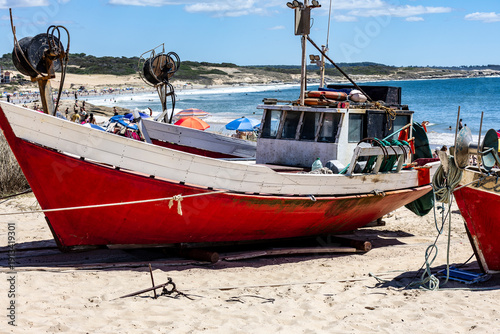Artisanal fishing boat resting on the beach in Punta del Diablo, Uruguay.
