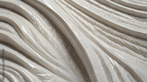 A close-up of a white surface decorated with a repeating wavy pattern. The design consists of soft, flowing curves that create a three-dimensional ripple effect, evoking a sense of movement and calm.