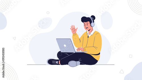 Young man with headphones waving hello on video call with laptop