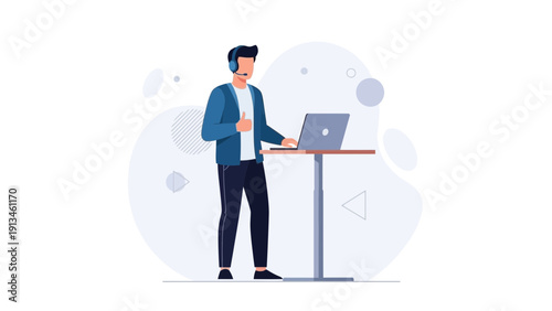 Man with headset giving thumbs up while working on laptop at standing desk