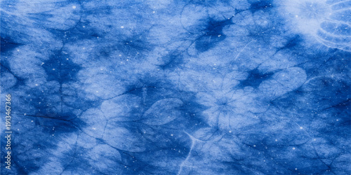 A beautiful abstract blue background featuring bright water drops under a clear summer sky with fluffy white clouds and radiant sunlight