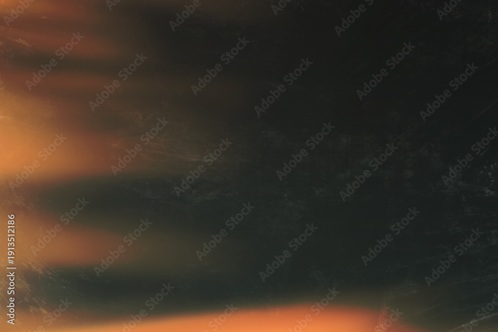 Obraz premium An abstract image featuring a vibrant orange streak against a dark textured black background high-quality