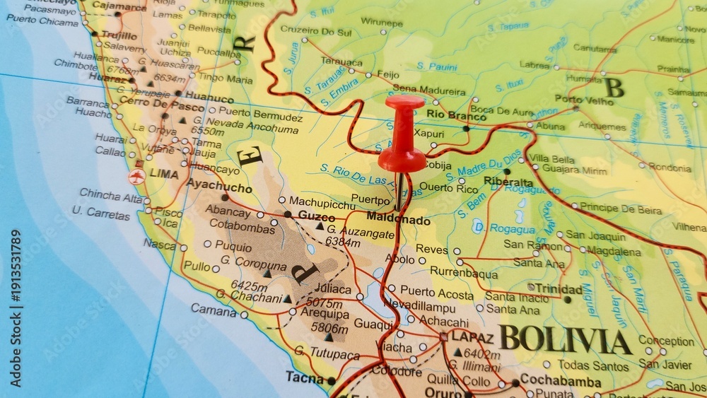 Obraz premium View of Puerto Maldonado, Capital city of Madre de Dios, Peru, on a geographical map of America, marked with red push pin