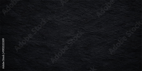 A dark, rough black paper texture with a grunge material surface creates a grey textured backdrop pattern suitable for a macro canvas wallpaper or textile design