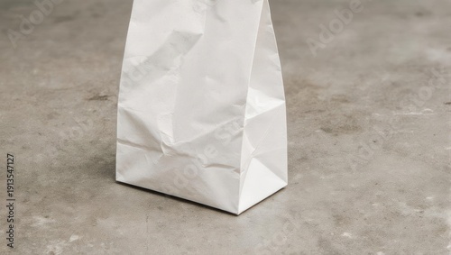 White Paper Bag on Gray Surface, Minimalist and Simple.