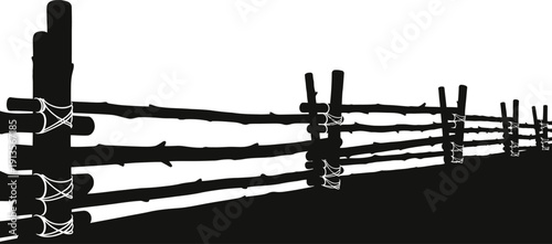 Black and white image of a rustic wooden fence in a rural setting