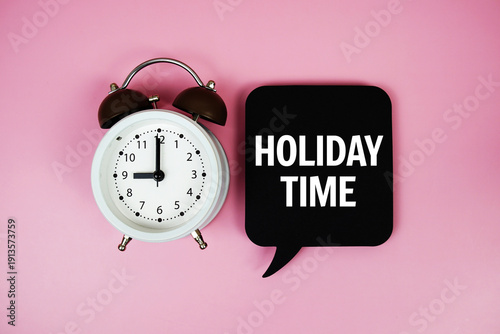 Holiday Time text on speech bubble with alarm clock on pink background