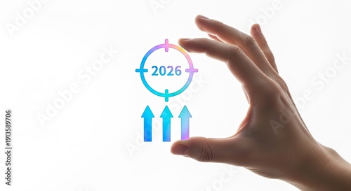 Hand holding a transparent target with 2026 and upward arrows, symbolizing future goals and progress.