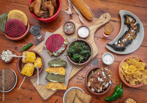 Wallpaper Mural mixed colombian and venezuelan food meal spread on wooden restaurant table Torontodigital.ca