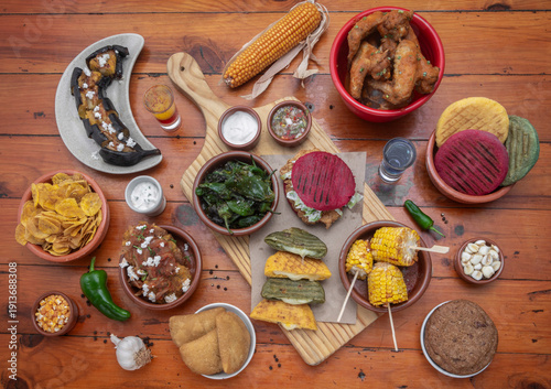 Wallpaper Mural mixed colombian and venezuelan food meal spread on wooden restaurant table Torontodigital.ca