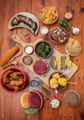 Wallpaper Mural mixed colombian and venezuelan food meal spread on wooden restaurant table Torontodigital.ca