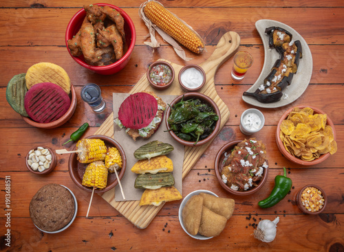 Wallpaper Mural mixed colombian and venezuelan food meal spread on wooden restaurant table Torontodigital.ca