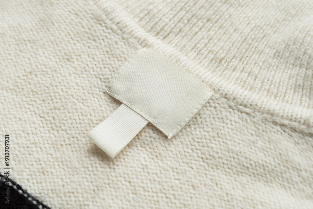 Obraz premium Blank White Clothing Label on Knitted Fabric