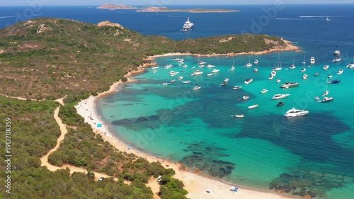 A postcard-perfect view of Sardinia’s Costa Smeralda, where azure waters, golden sands, and luxurious yachts define summer.