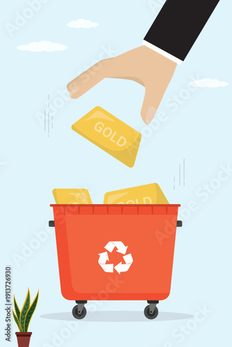 Hand drops gold bar into red recycling bin. Deep financial crisis, gold devaluation, assets becoming worthless. Falling precious metal prices, abandonment of gold investments.