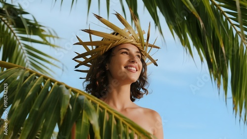 Woman wearing straw hat under palm tree