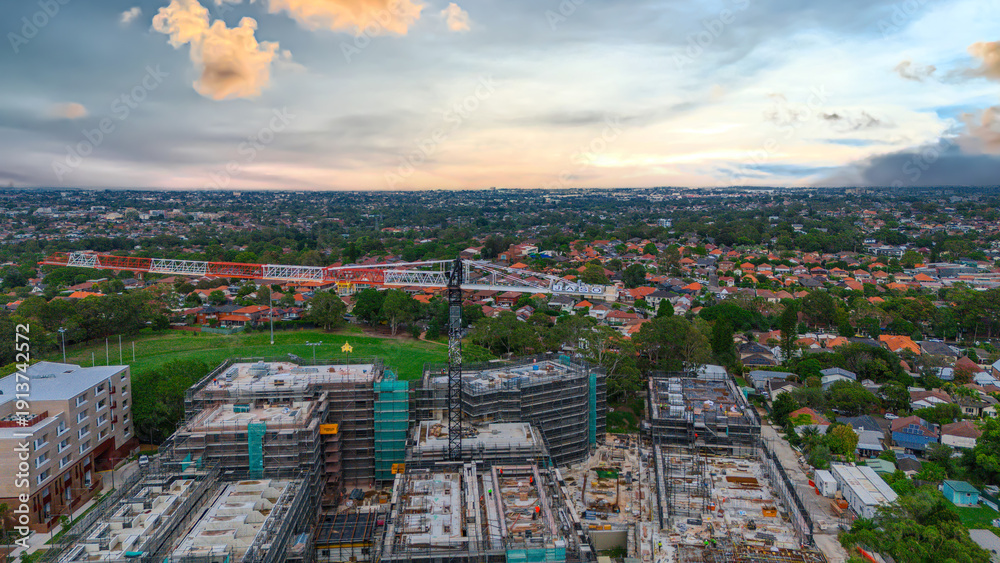 Obraz premium Panoramic Aerial Drone view of Inner Western Suburbs of Sydney housing, roof tops, the streets and the parks, the roads and trees of Ashbury Ashfield Burwood Summer Hill Canterbury and Campsie in Sydn
