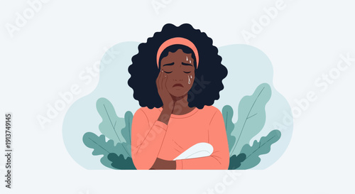 Woman in coral shirt crying, holding a sanitary pad, with plants