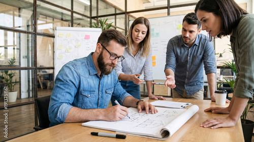 Male designer sketching ideas with team
