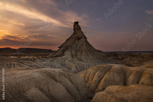 Dramatic evening light over the iconic Castildetierra formation, Bardenas Blanca, Spain.