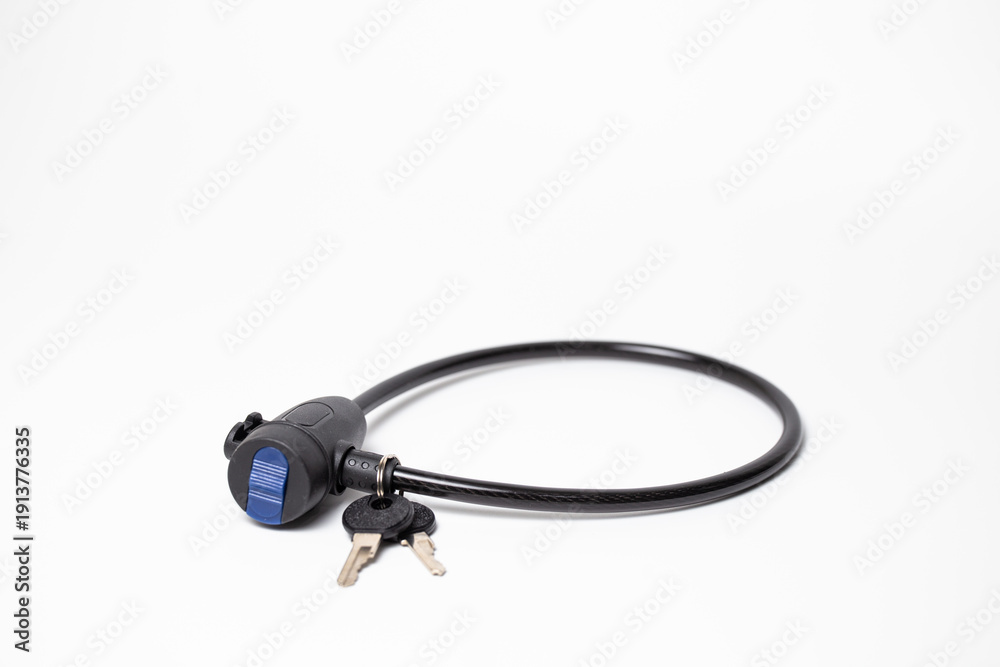 Fototapeta premium Close-up of black disc brake lock with reminder cable and keys on white background