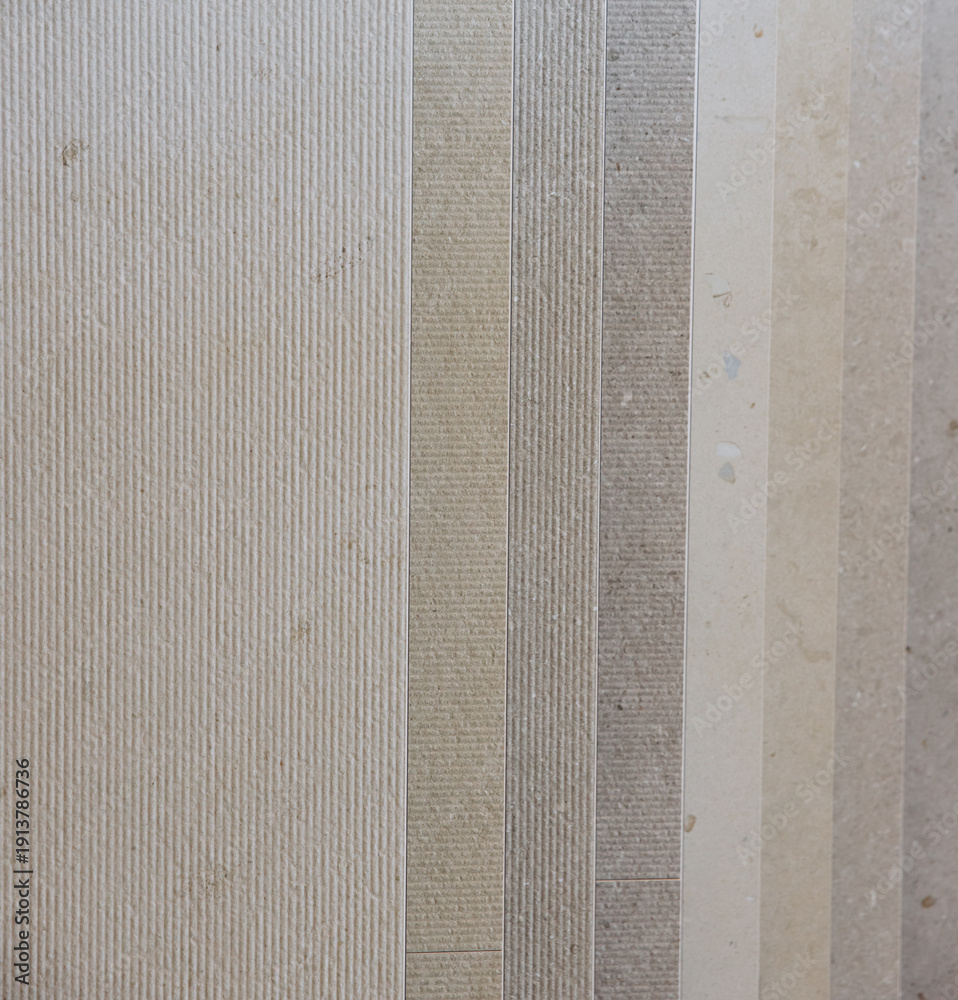 Fototapeta premium Stone tile samples displaying textured and smooth finishes, a neutral color palette for construction and interior design materials