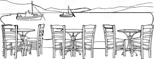 Outdoor cafe seating by the water with boats and distant hills