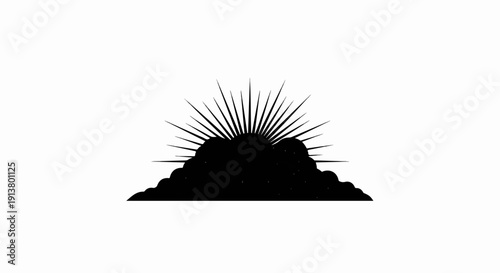 Silhouette of sunburst rising behind cloudy horizon