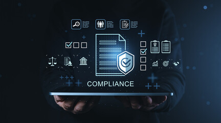 Compliance management concept with document and security icons floating above digital tablet held in hands on dark blue business background.